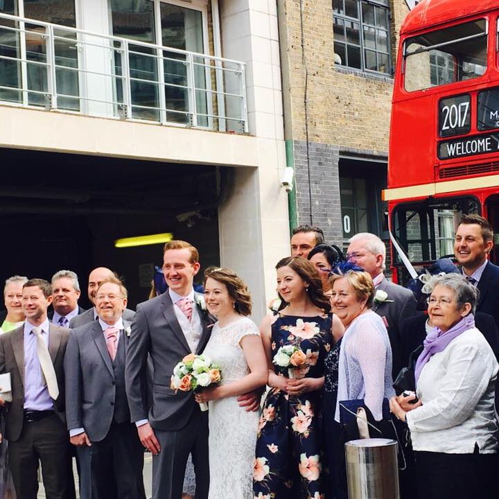 Wedding guests outside the classic routemaster bus